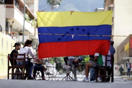 People are seen behind a barricade during a strike called to protest against Venezuelan President Nicolas Maduro