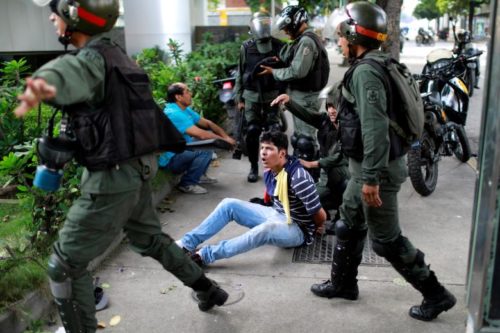 A demonstrator is detained at a rally during a strike called to protest against Venezuelan President Nicolas Maduro