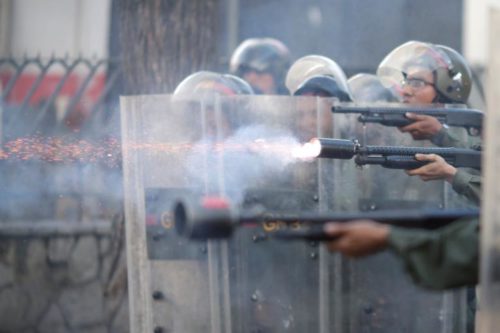 Riot security forces fire at a rally during a strike called to protest against Venezuelan President Nicolas Maduro