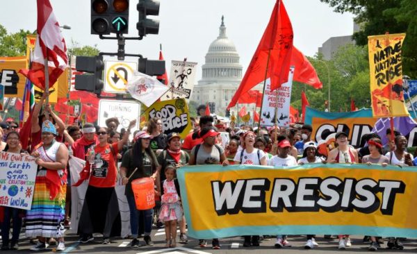 Demonstrators march down Pennsylvania Avenue during a People