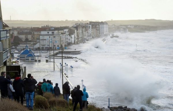 AFP / FRANCOIS LO PRESTI A crowd watched as massive waves flooded the seafront of Wimereux, northern France, on Wednesday