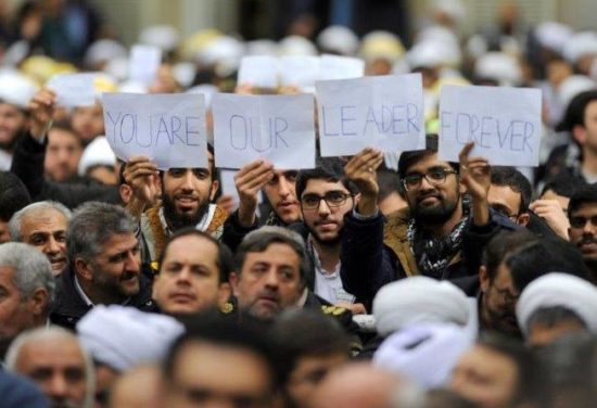 People hold signs as Iran s Supreme Leader Ayatollah Ali Khamenei speaks, Iran, January 9, 2018. Leader.ir/Handout via REUTERS