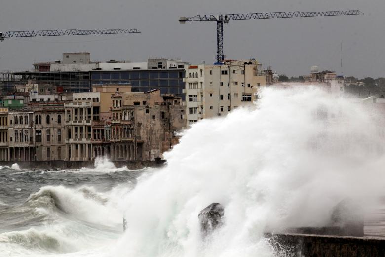 Waves crash against the seafront boulevard of El Malecon in Havana, Cuba. REUTERS/Stringer