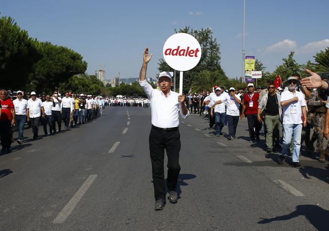 Turkey’s main opposition Republican People’s Party (CHP) leader Kemal Kilicdaroglu walks on the final stage of his 25-day long protest, dubbed “Justice March”, against the detention of the party’s lawmaker Enis Berberoglu, in Istanbul, Turkey, July 9, 2017. Placards read 