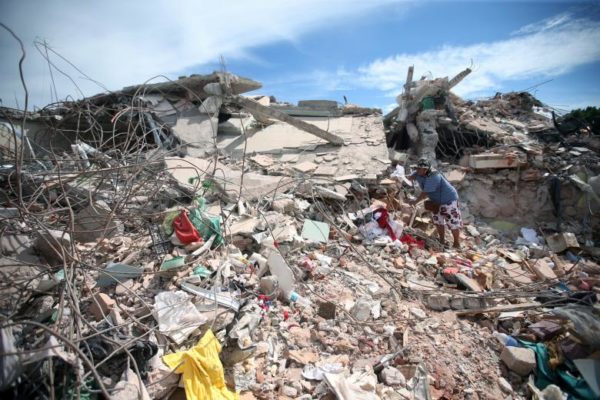 A woman looks through the rubble of a destroyed house after an earthquake, in Jojutla de Juarez, Mexico. REUTERS/Edgard Garrido