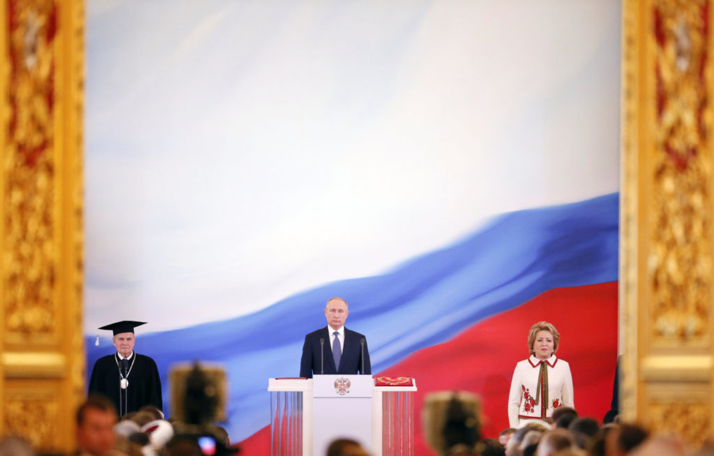 Vladimir Putin (C) is sworn as Russian President, with Chairman of the Constitutional Court Valery Zorkin (L) and Chairwoman of the Federation Council Valentina Matviyenko seen nearby, during an inauguration ceremony at the Kremlin in Moscow, Russia May 7, 2018. Sputnik/Kremlin via REUTERS ATTENTION EDITORS - THIS IMAGE WAS PROVIDED BY A THIRD PARTY.