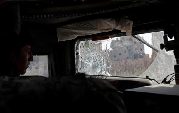 A member of Syrian Democratic Forces drives a vehicle past destroyed buildings in Raqqa. REUTERS/Erik De Castro